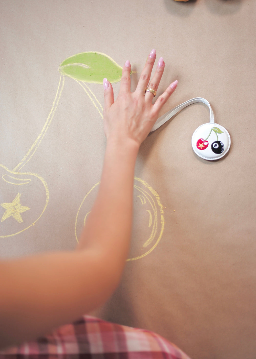 Hand pressing a button on a wall with decorative elements
